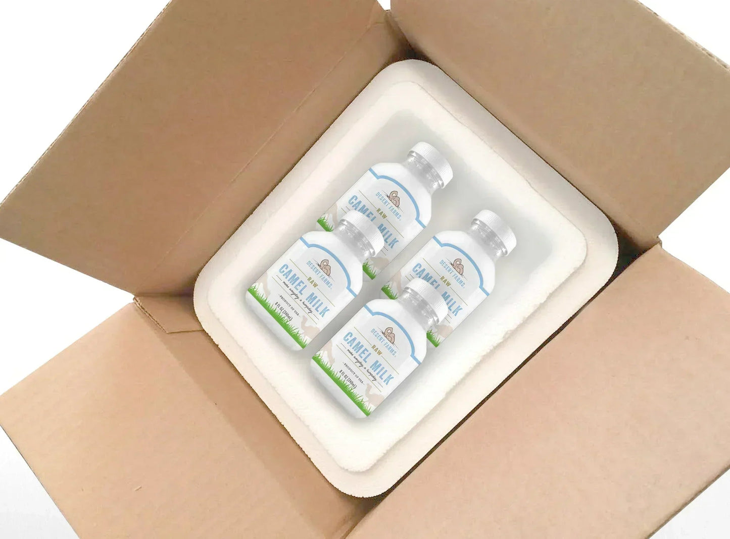 Three bottles of 'Caribou Milk' in a cardboard box with a styrofoam liner.